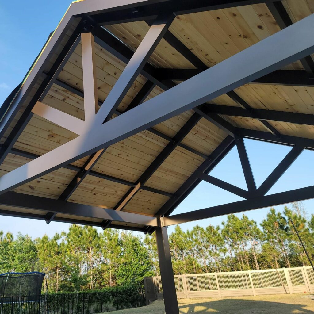 Aluminum pergola with pine wood ceiling by Florida Outdoor Products.