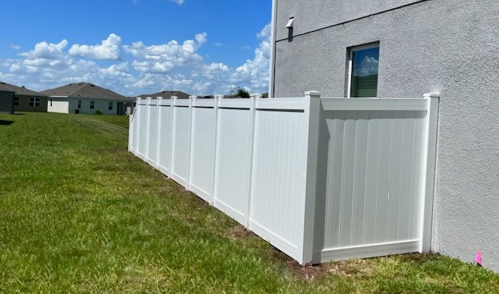 A 6' tall tongue and groove white vinyl fence providing unmatched privacy.